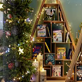 Festive Christmas Shop Window Display With Decorative Trees Stacked Books Stars Moon And Lights