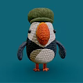 Knitted Puffin Doll With Green Hat Orange Beak Blue And White Body On Blue Background