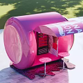 Outdoor Pink Can Shaped Kiosk With Display Shelves And Green Surroundings