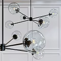 Modern Chandelier with Transparent Glass Globes and Black Metal Frame in Interior