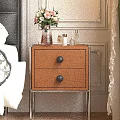 Wooden Bedside Table With Drawers Black Knobs Metal Legs And Vase With Flowers