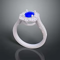 Exquisite White Metal Ring with Central Blue Gemstone Surrounded by Sparkling Diamond Accents