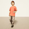 Man in orange T-shirt and gray jeans standing on light colored floor with light walls