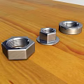 Stainless Steel Hardware Nuts Various Types On Wooden Tabletop