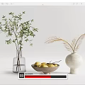 Glass Vase With Green Branches And White Vase With Feathery Plants Alongside Wooden Bowl Of Lemons
