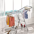 Sturdy Metal Foldable Clothes Drying Rack With Hanging Clothes And Shoes Near Window