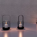 Decorative Ornament Set With Glass Lanterns Black Metal Handles Lit White Candles And Light Shadows