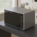 Gray Modern Microwave Oven As Kitchen Appliance On Dark Wooden Table With Window Blinds