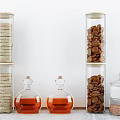 Clear Cylindrical Spice Bottles With Cork Stoppers Holding Various Spices On Kitchen Countertop