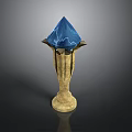 Blue Crystal Gemstone On Golden Decorative Stand With Petal Design