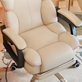 Comfortable Beige Office Chair With Black Armrests Wheels And Wooden Desk In Cozy Home Office