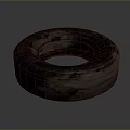 Used Car Tire With Worn Tread And Dark Surface On Gray Background