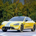 Yellow Sports Car With Racing Stripes On Wooded Road Surface