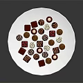 Assorted Chocolates in Red Brown White Colors and Various Shapes on White Plate
