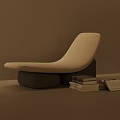Modern White Curved Lounge Chair with Gray Base and Stacked Books in Interior