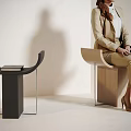 Modern Curved Wooden Stool with Woman Sitting and Black Curved Stool with Books Near White Wall