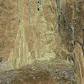 Natural Cave Interior Featuring Stalactites Stalagmites Rock Walls And Rocky Ground