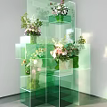 Creative Art Installation With Stacked Green Transparent Cubes And Flower Decorations
