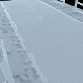 Road Infrastructure Cracked Asphalt Pavement With Grass Verge And Wooden Fence