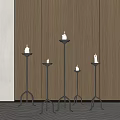 Multiple Black Metal Candle Lamps In Different Heights With Dark Wooden Wall And Light Carpet