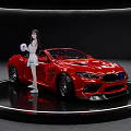 Red Convertible Sports Car With Girl In White Outfit On Black Display Platform