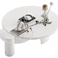 Modern Minimalist White Round Coffee Table With Decorative Items Green Plant And Figurine