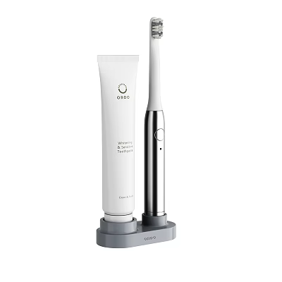 Daily Cleaning Essentials White Toothpaste Tube And White Silver Electric Toothbrush On Gray Stand 3d model