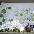 Tranquil Indoor Landscape Design With Hanging Green Spheres Deer Sculpture Small Tree And Round Lamp