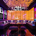 Modern KTV Lounge Interior With Neon Lights Sofa Seating And Decorative Chandelier