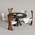 Modern Round Dining Table With Black Top And Mixed Chairs Featuring Fruits And Open Book
