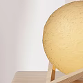 Yellow Globe Table Lamp with Wooden Stand on Wooden Table White Wall and Wall Art