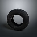 Isolated Automotive Tire with Deep Tread Pattern on Gray Background