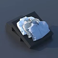 Neatly Folded Light Blue And White Shirts Placed On Black Box