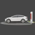 White Tesla SUV Electric Car Charging At Tesla Charging Station In Parking Lot
