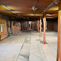 Ancient Building Interior With Wooden Pillars Stone Floor And Traditional Wooden Walls