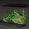 Scenic Green Mountainous Landscape With Winding Road And Wind Turbine In Transparent Cube