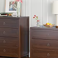 Three Wooden Chests of Drawers with Table Lamps Vases and Green Plant on Wooden Floor
