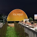 Elegant Outdoor Night Banquet Setup With Long Tables Green Lawn And Yellow Backdrop