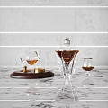 Elegant Crystal Decanter And Wine Glass With Gold Accents On Marble Countertop Gray Wall Lighting