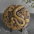 Brass Circular Decorative Ornament Set Featuring Snake And Coin Patterns On Marble Tabletop