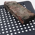 Rustic Textured Stone Brick Placed On Black Perforated Tray Closeup View