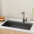 Black Kitchen Sink With Modern Faucet On White Countertop With Fruits And Plant