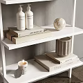 Modern White Wall Shelving Unit With Neatly Arranged Decorative Plates Bottles And Vases