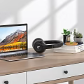 Modern Laptop With Scenic Screen On Wooden Desk With Black Headphones Books And Potted Plants