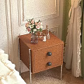 Wooden Bedside Table With Drawers Black Knobs Metal Legs And Vase With Flowers