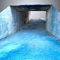 Concrete Tunnel with Graffiti Covered Walls Blue Painted Floor Ceiling Opening and Natural Light
