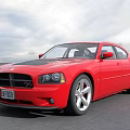 Red Sports Sedan With Black Roof Silver Alloy Wheels And Cloudy Sky