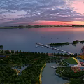 Scenic Garden Landscape at Sunset With Lake Lush Trees Boardwalk and Green Space