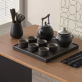 Black Tea Set on Wooden Table with Teapot Tea Cups Tray and Chopsticks Utensil Holder