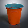 Vibrant Orange Garden Flower Pot With Blue Rim And Fresh Soil Inside